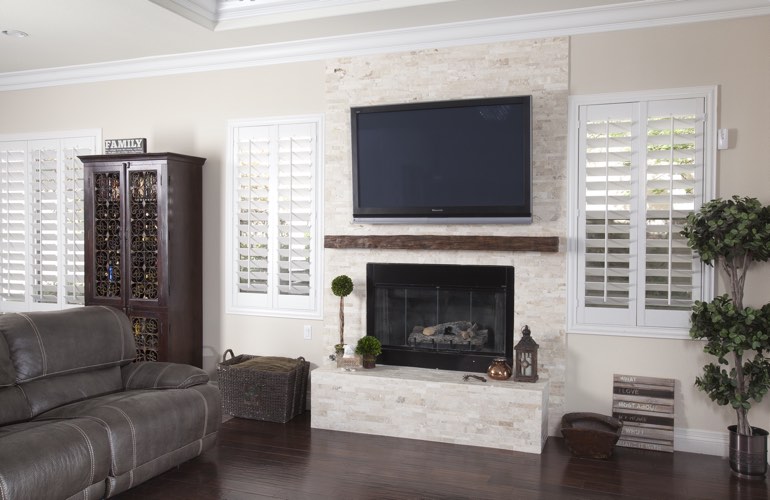 White plantation shutters in a Cincinnati living room with solid hardwood floors.
